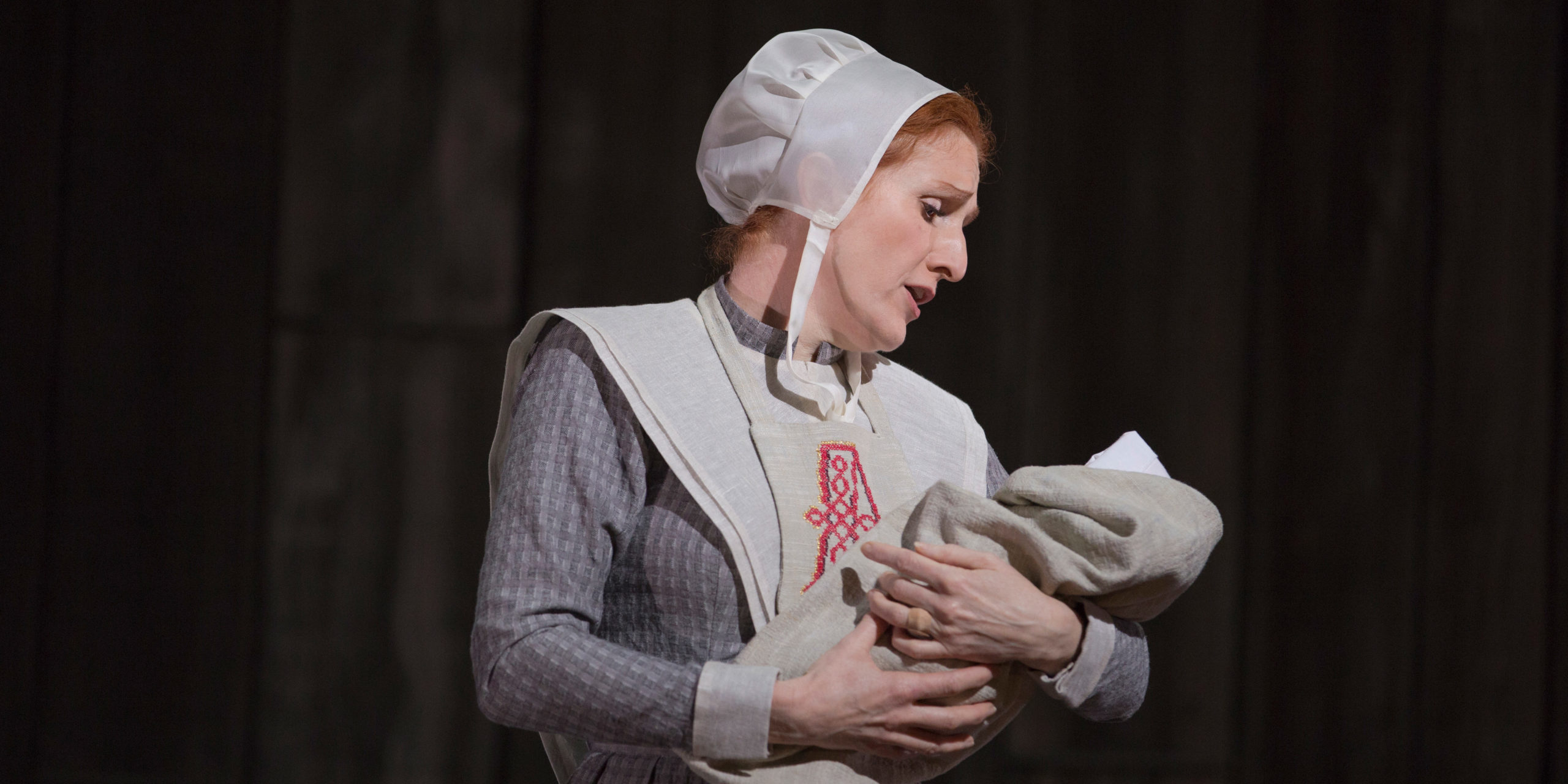 Hester Prynne (played by soprano Laura Claycomb) cradles her infant daughter and sings her a lullaby.