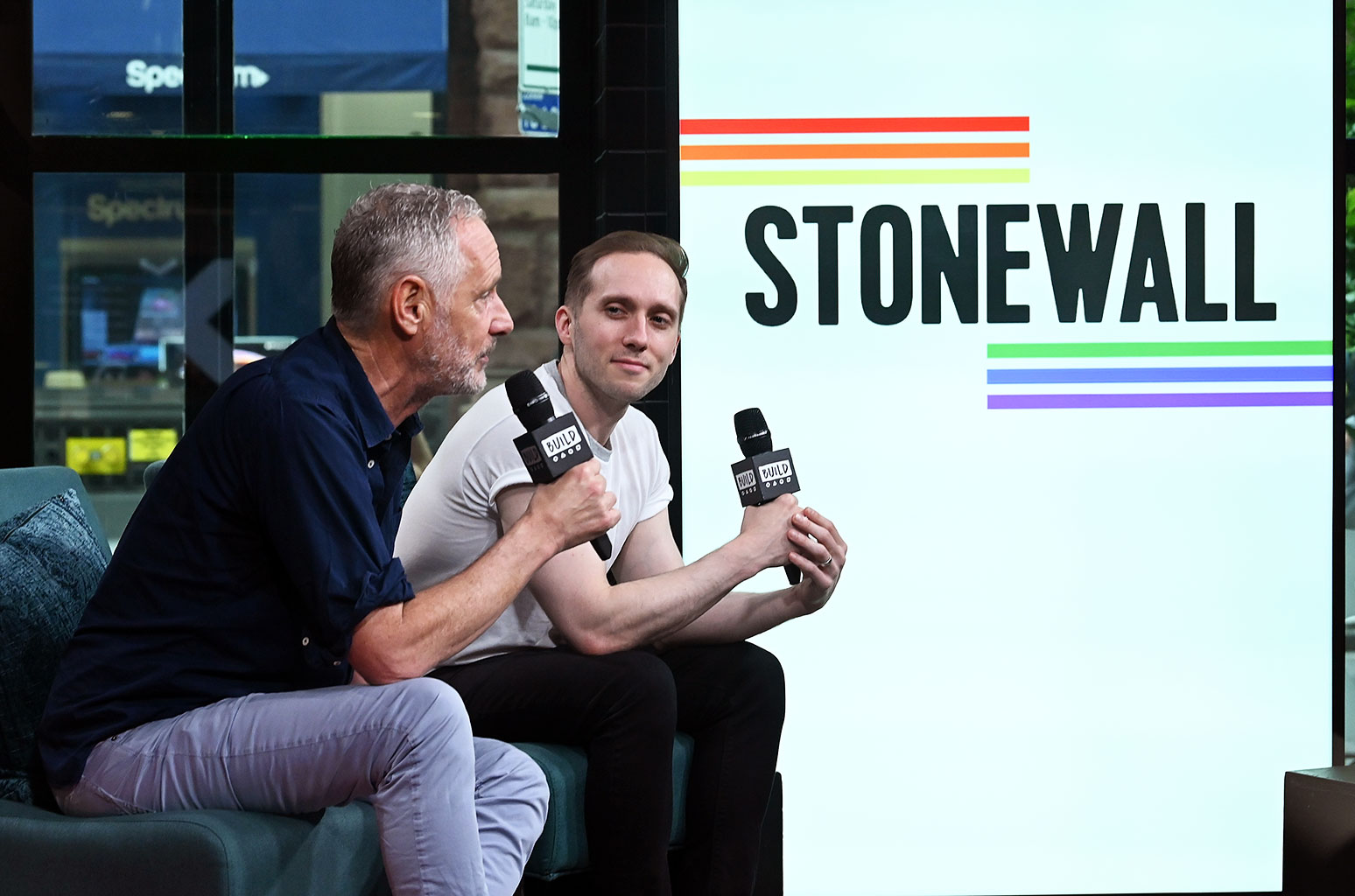 Mark Campbell sits for an interview with the artwork for Stonewall in the background.