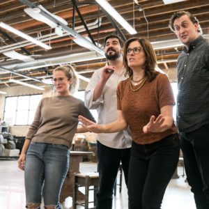 Kate Aldrich in rehearsal surrounded by other performers.