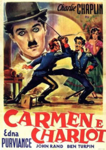 Poster for Charlie Chaplin’s 1915 A Burlesque on Carmen featuring a drawing of two men having a sword fight as a woman, Carmen, stands in the background.