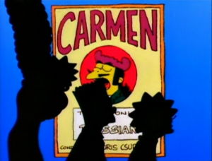 The silhouette of the Simpson family in front of a yellow poster with Carmen written on top.