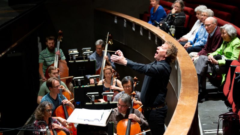 A view into the orchestra pit at the Ellie Caulkins Opera House while Maestro Ari Pelto conducts.