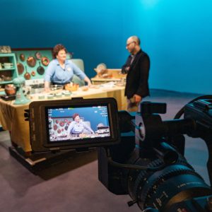 Catherine Cook as Julia Child speaks to director David Lefkowich while the video camera frames Catherine.