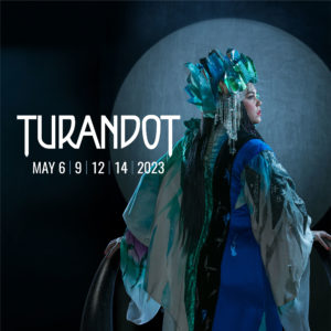 A woman stands in profile with an elaborate blue, green, and silver costume. She wears an ice-like crown and is surrounded by a stark spotlight. Text reads: Turandot | May 6, 9, 12, 14, 2023