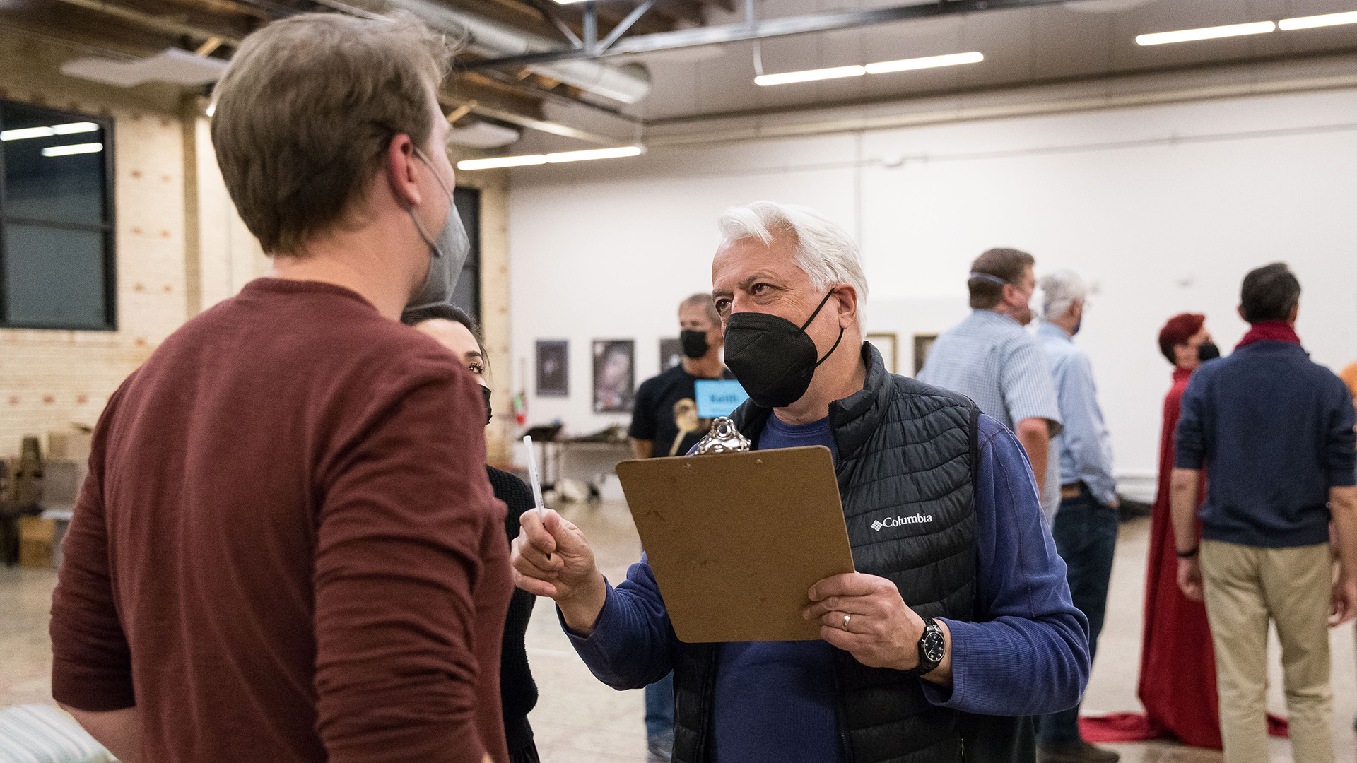 Director Christopher Mattaliano works with the cast of Opera Colorado's 2022 production of Rigoletto.
