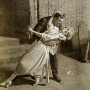 Sepia photo of a man and woman dancing.