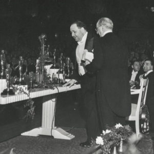 Black and white photo of a man receiving an award