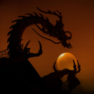 A dragon holding an orange orb from the sets on Turandot by Lyrics Opera of Chicago