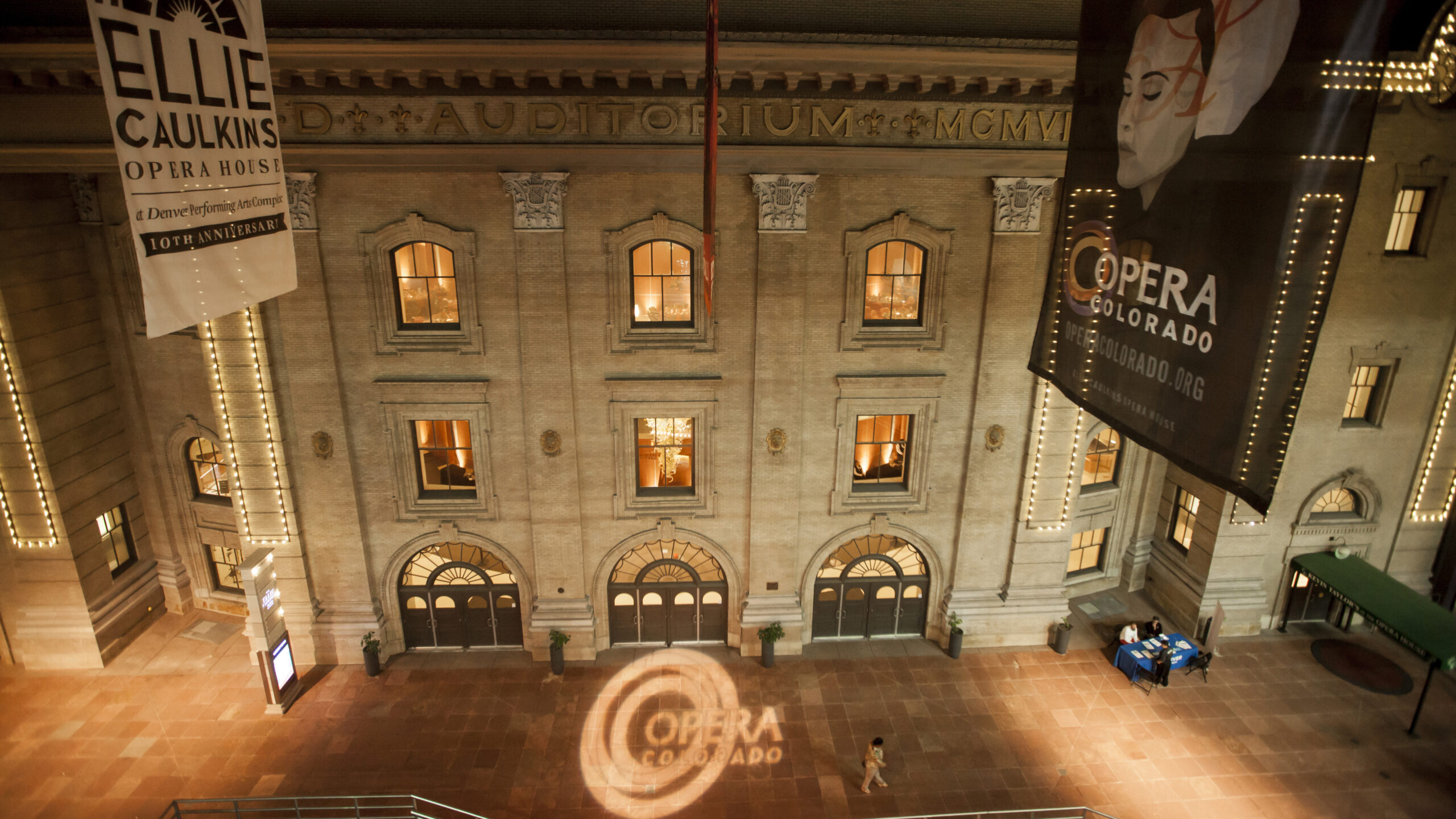 A building at night with six windows and three doors