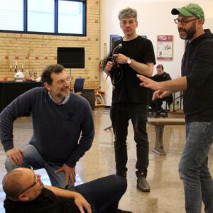 Four men talk about their staging in a rehearsal