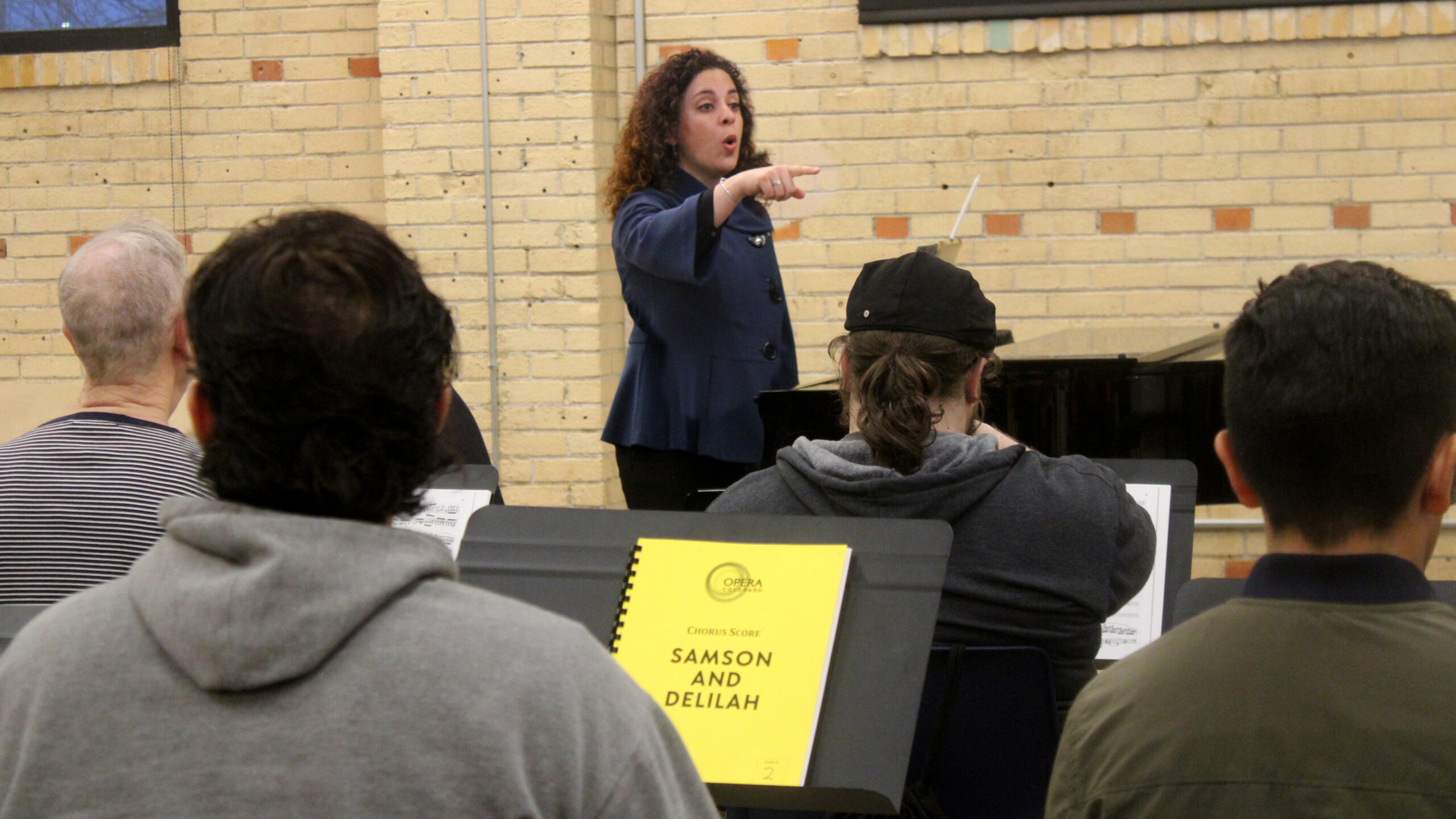 A book reading "Samson and Delilah" sits on a music stand